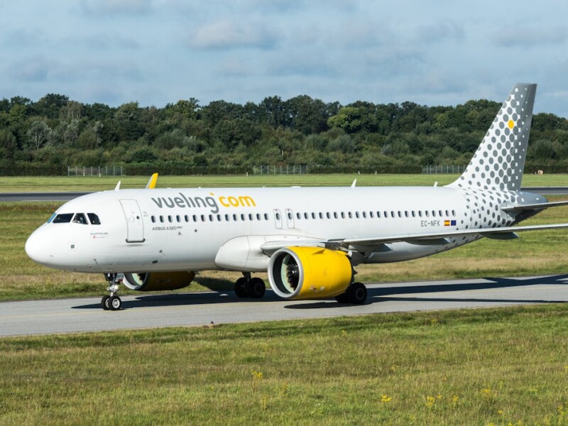 Vueling aircraft on runway at Barcelona airport with yellow engines