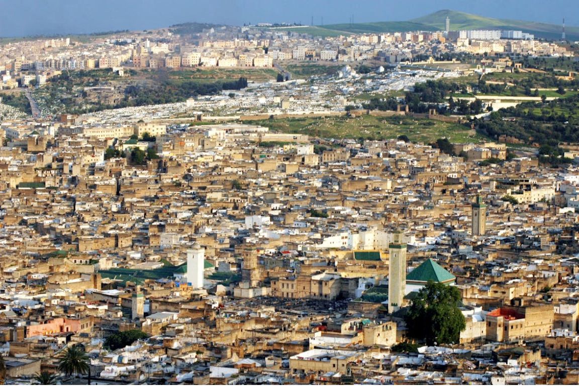 Aerial view of Fez medina with historic mosques and dense architecture