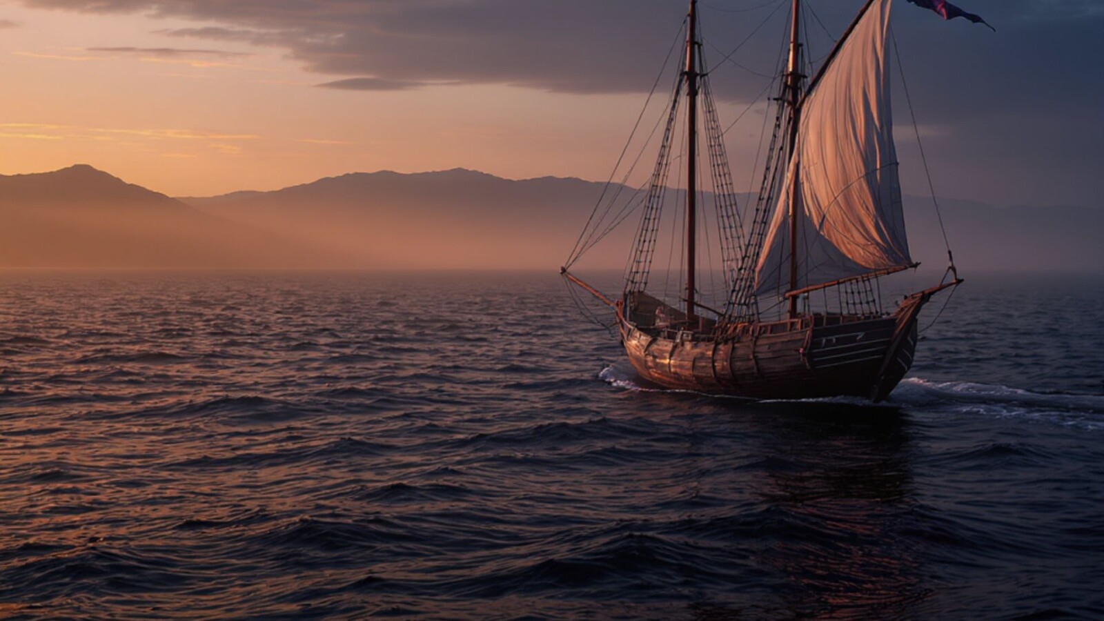 # Alt Text for MoroFun.com Historic sailing ship with billowed sails at sunset near mountains