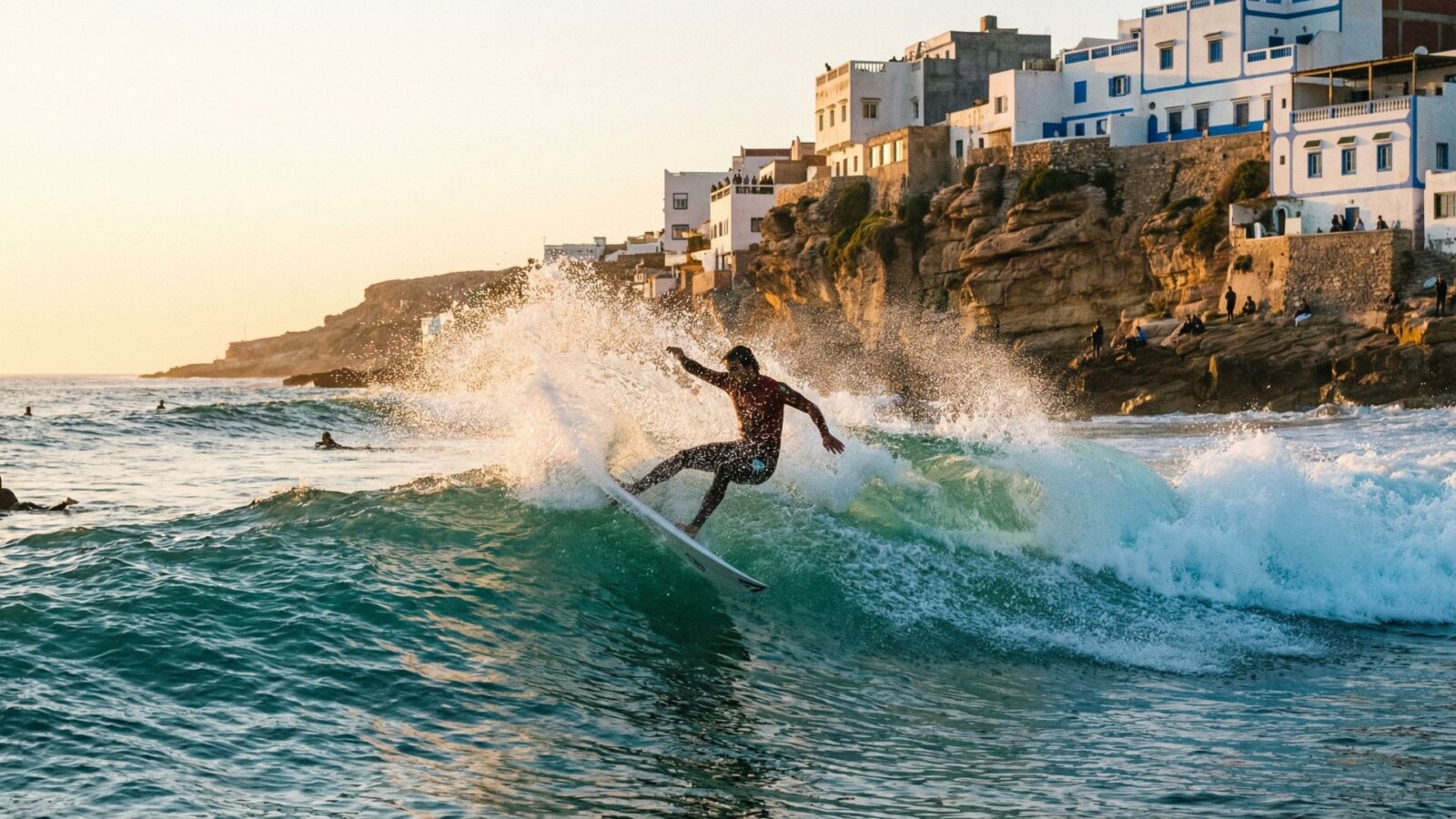 Surfer catching a wave at Taghazout beach on Morocco's Atlantic coast