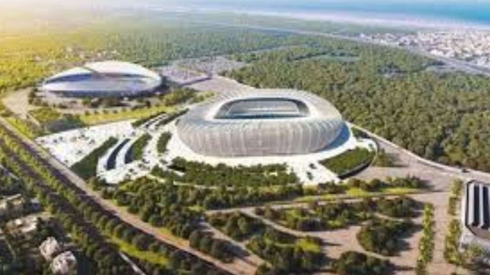 Aerial view of modern stadium complex in forested Morocco landscape