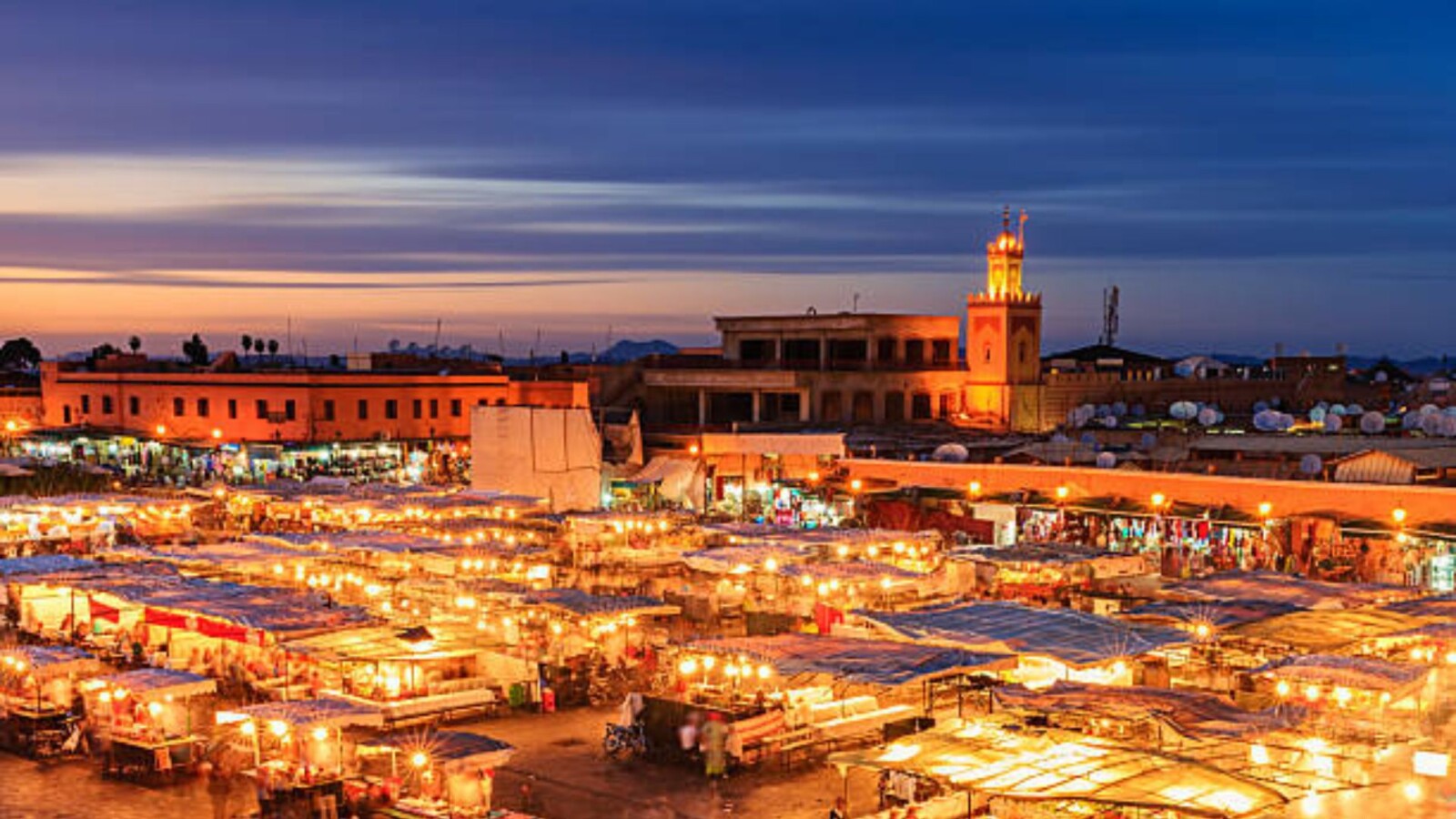 Jemaa el-Fnaa square Marrakech illuminated at sunset with leather tanneries