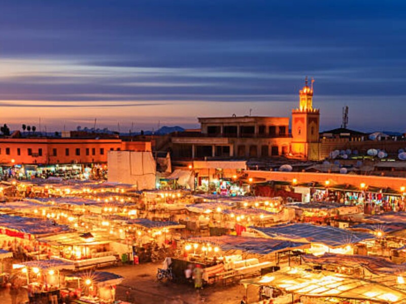 Jemaa el-Fnaa square Marrakech illuminated at sunset with leather tanneries