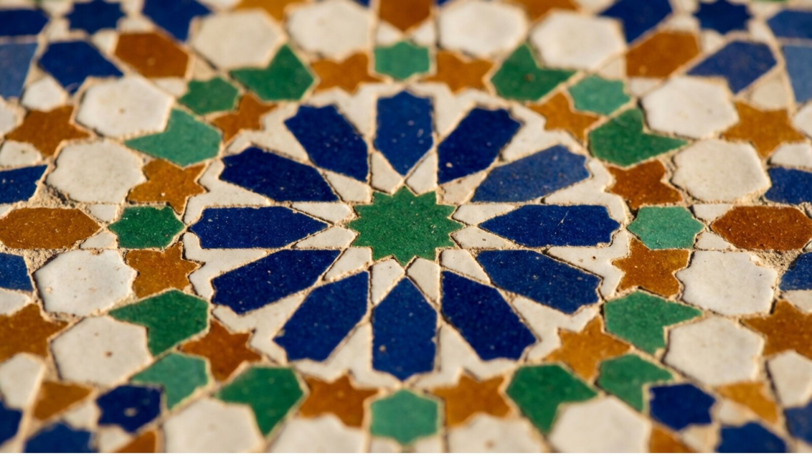 Intricate geometric zellige tile pattern with blue green and brown stars