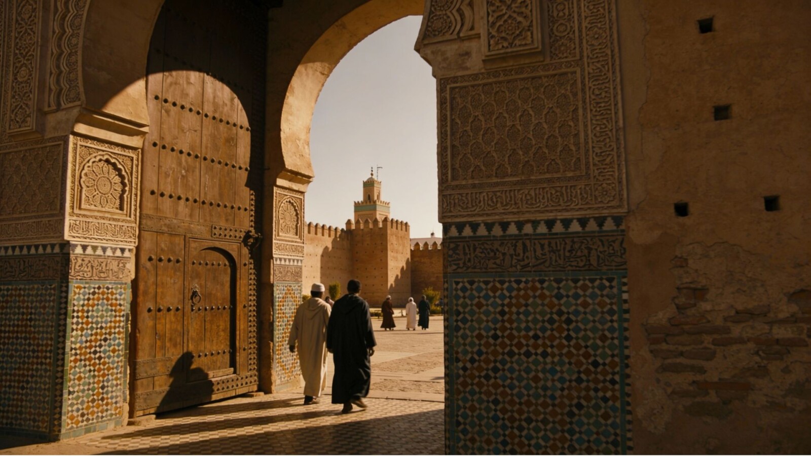# Alt Text Ornate archway framing Al-Hakim Mosque courtyard in historic Islamic Cairo